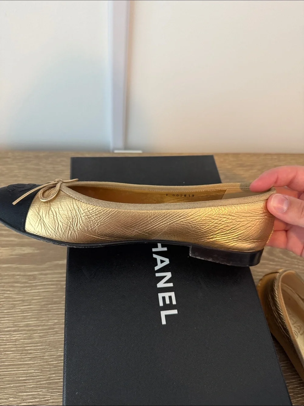 CHANEL Gold Leather Ballet Flats with Black Cap-Toe